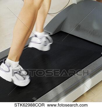 Stock Photo - close-up low section 
of the feet of 
a woman running 
on a treadmill. 
fotosearch - search 
stock photos, 
pictures, images, 
and photo clipart