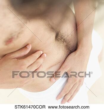 Stock Photo - elevated view 
of a man looking 
at a scar on his 
stomach. fotosearch 
- search stock 
photos, pictures, 
images, and photo 
clipart