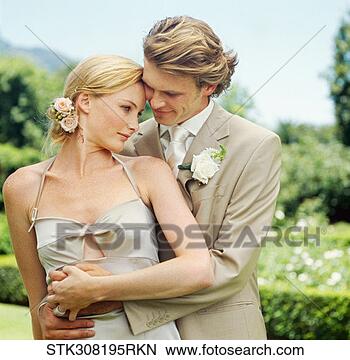 Stock Photo - newly wed couple 
embracing each 
other on a lawn. 
fotosearch - search 
stock photos, 
pictures, images, 
and photo clipart