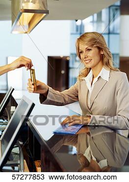 Stock Photo - receptionist handing 
over keys to a 
businesswoman. 
fotosearch - search 
stock photos, 
pictures, images, 
and photo clipart