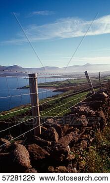 Stock Photo - view of brandon 
point,  co kerry, 
 ireland behind 
a wire fence on 
a. fotosearch 
- search stock 
photos, pictures, 
images, and photo 
clipart