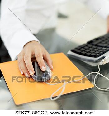 Stock Photo - woman's hand operating 
a computer mouse. 
fotosearch - search 
stock photos, 
pictures, images, 
and photo clipart