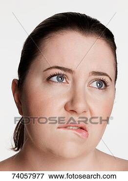 Picture - young plus-size 
woman biting lip, 
looking away. 
fotosearch - search 
stock photos, 
pictures, images, 
and photo clipart