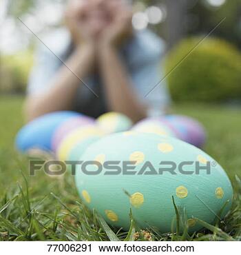 Stock Photography - boy and easter 
eggs on lawn (focus 
on foreground). 
fotosearch - search 
stock photos, 
pictures, images, 
and photo clipart