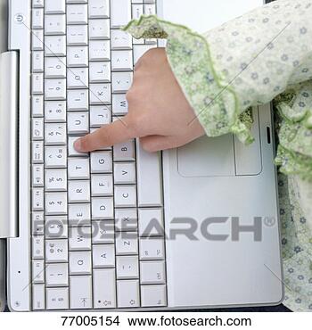 Stock Photo - girl (7-9) pressing 
key on laptop 
keyboard, close-up, 
overhead view. 
fotosearch - search 
stock photos, 
pictures, images, 
and photo clipart