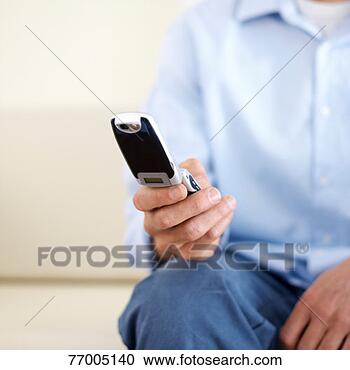 Stock Photography - man text messaging, 
mid section, close-up 
of hand. fotosearch 
- search stock 
photos, pictures, 
images, and photo 
clipart