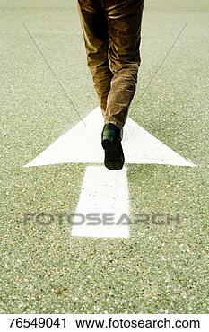 Stock Photography - person walking 
in direction of 
arrow on road. 
fotosearch - search 
stock photos, 
pictures, images, 
and photo clipart
