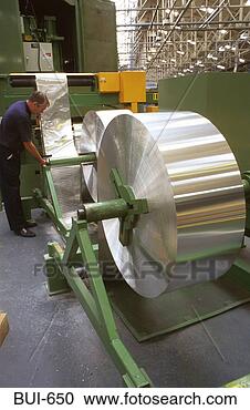 Stock Photography - man handling roll 
of sheet metal 
wales uk. fotosearch 
- search stock 
photos, pictures, 
images, and photo 
clipart