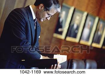 Stock Photograph - eyeglasses, reading, 
business, middle-aged, 
businessman, indoors. 
fotosearch - search 
stock photos, 
pictures, images, 
and photo clipart