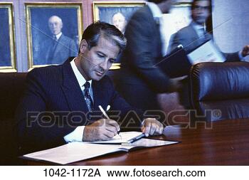 Stock Photo - group, men, pen, 
desk, paperwork, 
business, writing. 
fotosearch - search 
stock photos, 
pictures, images, 
and photo clipart