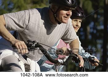 Stock Photo - people, couple, 
senior, bicycle, 
outdoors, sports. 
fotosearch - search 
stock photos, 
pictures, images, 
and photo clipart