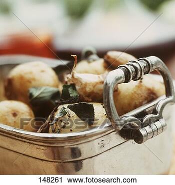Stock Photography - baked sage potatoes 
in a roasting 
dish. fotosearch 
- search stock 
photos, pictures, 
images, and photo 
clipart