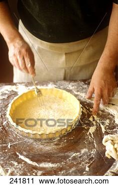 Stock Photography - pricking tart 
base with fork. 
fotosearch - search 
stock photos, 
pictures, images, 
and photo clipart
