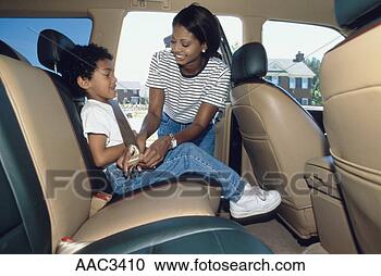Stock Photography - an african-american 
mother securing 
her son in a seat 
belt in the. fotosearch 
- search stock 
photos, pictures, 
images, and photo 
clipart