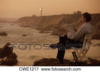 Picture - businessman with 
newspaper enjoying 
outdoor office 
near point arena. 
fotosearch - search 
stock photos, 
pictures, images, 
and photo clipart