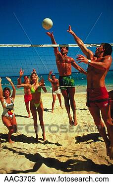 Stock Image - two men jump for 
the ball as a 
group of people 
play a game of 
beach. fotosearch 
- search stock 
photos, pictures, 
images, and photo 
clipart