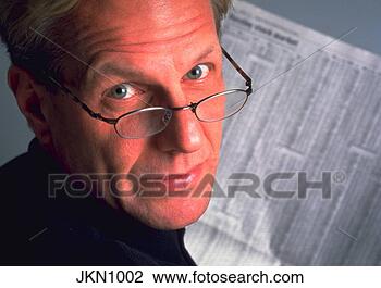 Stock Photo - close-up of a 
middle-aged man 
wearing glasses 
looking over his. 
fotosearch - search 
stock photos, 
pictures, images, 
and photo clipart