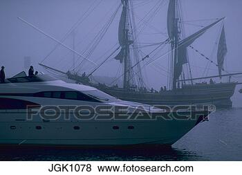Stock Photo - a modern yacht 
passing a tall 
sailing ship in 
the fog. fotosearch 
- search stock 
photos, pictures, 
images, and photo 
clipart