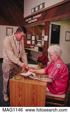 Stock Photo - hospital volunteer 
receptionist greets 
patient, ca. fotosearch 
- search stock 
photos, pictures, 
images, and photo 
clipart