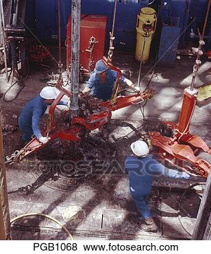 Stock Photo - oil rig casing 
crew  skilled 
crew working on 
an oil rig drill 
floor. fotosearch 
- search stock 
photos, pictures, 
images, and photo 
clipart