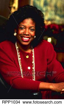 Stock Photo - portrait attractive 
black businesswoman 
in red suit w/pearls 
in green. fotosearch 
- search stock 
photos, pictures, 
images, and photo 
clipart