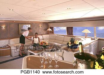 Stock Photography - saloon of a private 
motor cruiser 
a stewardess serving 
coffee to a. fotosearch 
- search stock 
photos, pictures, 
images, and photo 
clipart