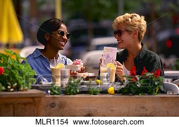 Stock Photo - two women eating 
lunch outside 
and exchanging 
a gift. fotosearch 
- search stock 
photos, pictures, 
images, and photo 
clipart