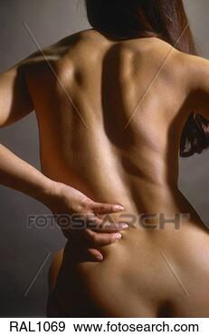Stock Photograph - view from behind 
a nude woman sitting 
down holding her 
lower back as. 
fotosearch - search 
stock photos, 
pictures, images, 
and photo clipart