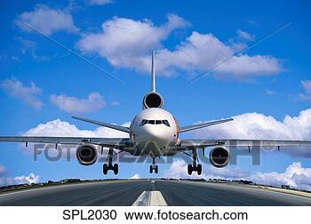 Stock Photography - dc-10 jet airplane 
taking off as 
seen from the 
end of the runway. 
fotosearch - search 
stock photos, 
pictures, images, 
and photo clipart