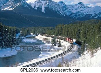 Stock Photo - train traveling 
on track around 
bend along river 
with snow-covered. 
fotosearch - search 
stock photos, 
pictures, images, 
and photo clipart