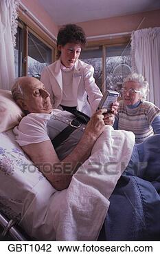 Stock Photo - home health care 
nurse teaches 
bedridden patient 
use of drug pump. 
fotosearch - search 
stock photos, 
pictures, images, 
and photo clipart