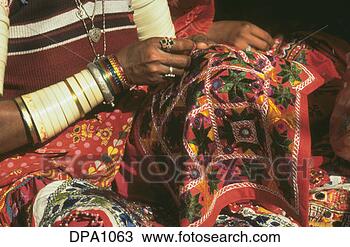 Stock Photo - lady with hand 
full of bangles 
doing fine embroidery 
work. fotosearch 
- search stock 
photos, pictures, 
images, and photo 
clipart