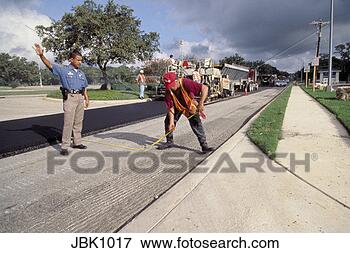 Picture - a police officer 
helps direct traffic 
while a crew use 
paving. fotosearch 
- search stock 
photos, pictures, 
images, and photo 
clipart
