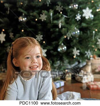 Stock Photography - portrait of a 
young girl with 
red hair smiling 
while sitting 
in front. fotosearch 
- search stock 
photos, pictures, 
images, and photo 
clipart