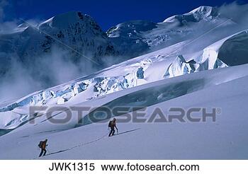 Stock Image - two mountain climbers 
ascending a snow-covered 
mountain. fotosearch 
- search stock 
photos, pictures, 
images, and photo 
clipart