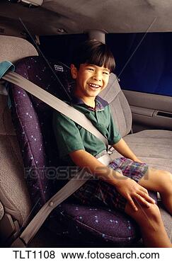 Stock Photo - a young phillipino 
boy sitting in 
a booster seat 
in the back of 
a car. fotosearch 
- search stock 
photos, pictures, 
images, and photo 
clipart
