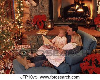 Stock Image - father reading 
to daughters by 
christmas tree 
property released. 
fotosearch - search 
stock photos, 
pictures, images, 
and photo clipart