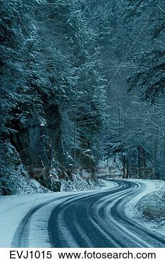 Stock Image - twisting road 
winds through 
snowy trees and 
rocks in the allegheny. 
fotosearch - search 
stock photos, 
pictures, images, 
and photo clipart