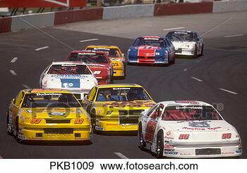 Stock Photograph - multi-colored 
race cars circling 
on a race track. 
fotosearch - search 
stock photos, 
pictures, images, 
and photo clipart