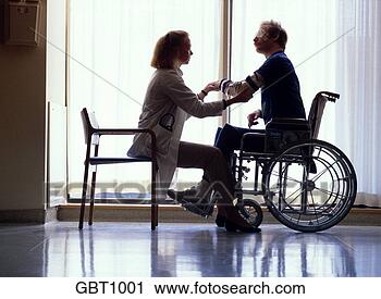 Stock Photography - a partially paralyzed 
patient sits in 
a wheelchair by 
the window as. 
fotosearch - search 
stock photos, 
pictures, images, 
and photo clipart