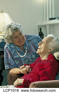 Stock Photo - senior woman talking 
to,  and holding 
the hand of,  
a very eledrly. 
fotosearch - search 
stock photos, 
pictures, images, 
and photo clipart