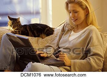 Stock Photo - thirty year old 
woman shopping 
on-line on her 
laptop while laying 
on. fotosearch 
- search stock 
photos, pictures, 
images, and photo 
clipart