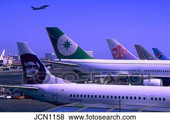 Stock Photo - view of several 
commercial airliners 
sitting at their 
gates while. fotosearch 
- search stock 
photos, pictures, 
images, and photo 
clipart