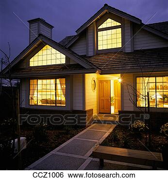 Stock Photo - warm yellow light 
shines out of 
the windows and 
the ajar front 
door. fotosearch 
- search stock 
photos, pictures, 
images, and photo 
clipart