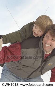 Stock Photo - father carries 
his young son 
on his back as 
they happily play 
in the. fotosearch 
- search stock 
photos, pictures, 
images, and photo 
clipart