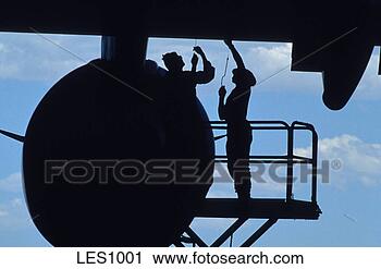 Stock Photography - silhouetted aircraft 
maintenance personnel 
work on a us air 
force. fotosearch 
- search stock 
photos, pictures, 
images, and photo 
clipart