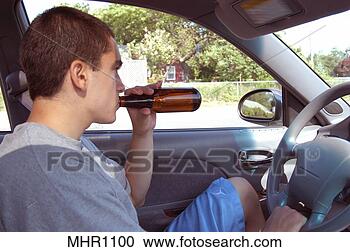 Stock Photography - teenage male drinking 
from a beer bottle 
while behind the 
wheel of a. fotosearch 
- search stock 
photos, pictures, 
images, and photo 
clipart