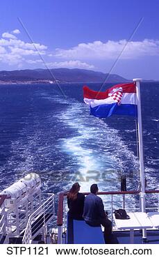 Stock Photography - young couple on 
the top deck of 
the jadrolinija 
ferry boat leaving. 
fotosearch - search 
stock photos, 
pictures, images, 
and photo clipart