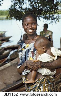 Stock Photo - portrait of smiling 
woman carrying 
baby along ngiri 
river. fotosearch 
- search stock 
photos, pictures, 
images, and photo 
clipart