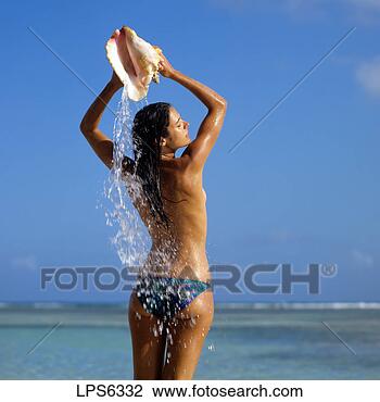 Stock Photo - mr topless young 
woman pouring 
water on her back 
from a conch shell. 
fotosearch - search 
stock photos, 
pictures, images, 
and photo clipart